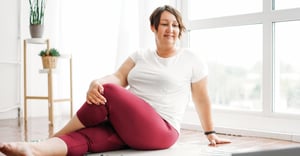 Woman completing workplace physical activity at home