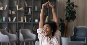 Woman stretching at work in her office