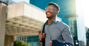 Happy man enjoying a walk outside after work