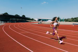 Woman running on a track