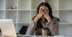 Woman employee stressed out at her desk at work