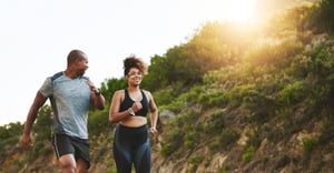 Happy couple running outside endorphins and exercise