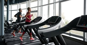 Senior man and woman working out in a gym