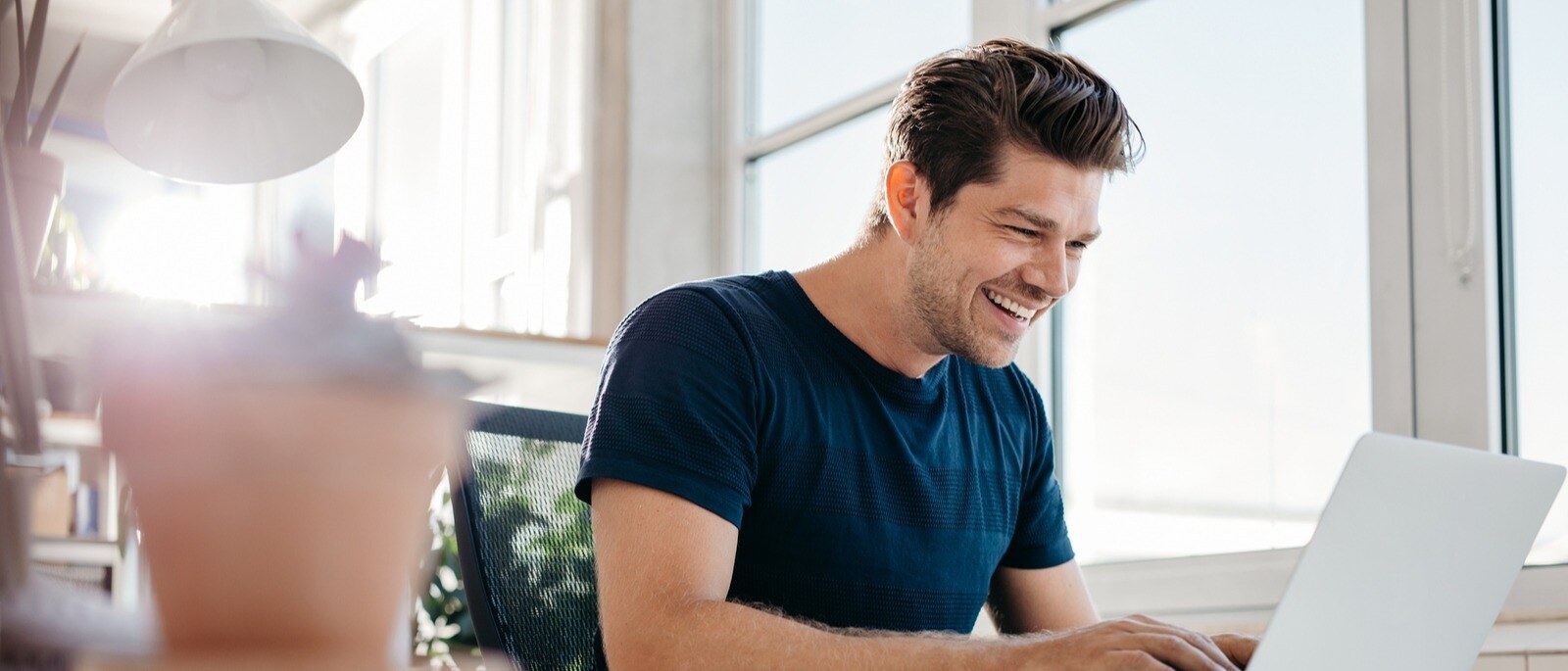 bigstock-Happy-Young-Businessman-Using-147353081