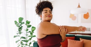 Woman working out in her home stretching