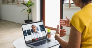 Senior woman talking with doctor on laptop