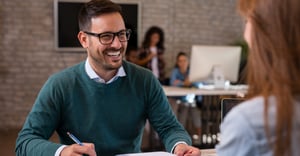 Employee working at desk with coworker